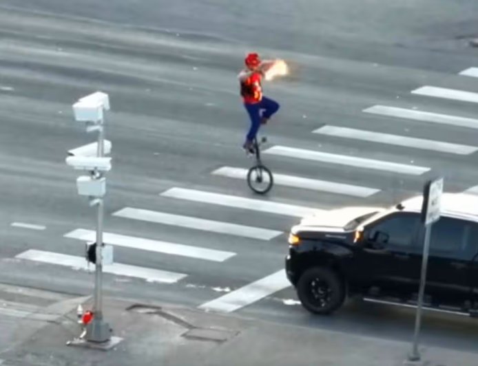 Cops catch fire-juggling unicyclist performing on crossing and admit he's 'quite good'